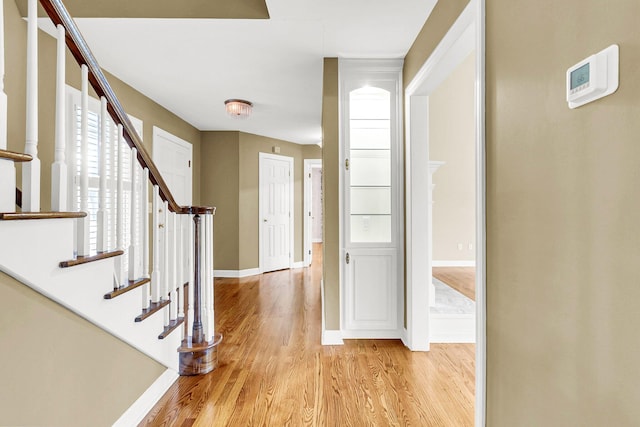 foyer entrance with light hardwood / wood-style floors