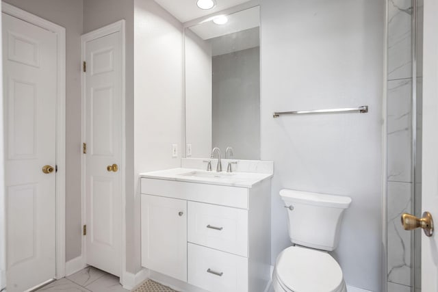 full bath with vanity, toilet, baseboards, and marble finish floor