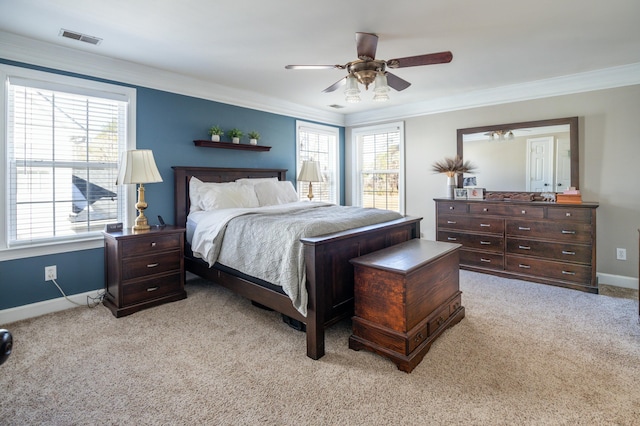 carpeted bedroom featuring multiple windows and ornamental molding