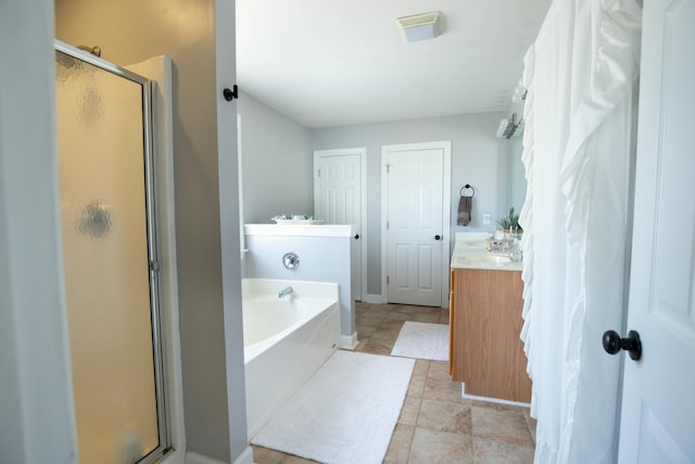 bathroom featuring vanity, tile patterned flooring, and plus walk in shower