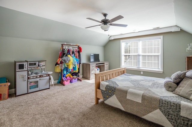 carpeted bedroom with vaulted ceiling and ceiling fan