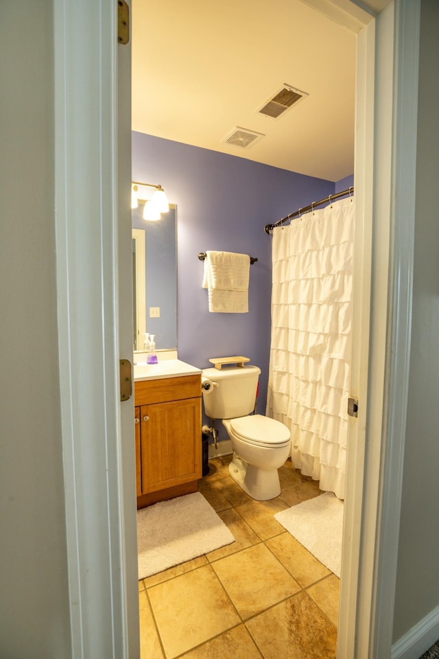 bathroom with vanity, tile patterned flooring, and toilet