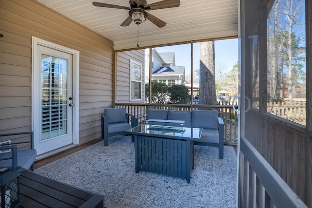 sunroom / solarium featuring ceiling fan