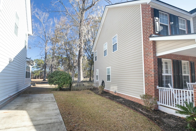 view of home's exterior featuring a yard and a patio