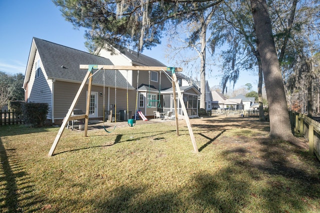 back of property with cooling unit and a lawn