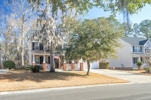 view of front of house featuring a porch and a garage