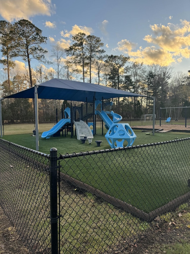 exterior space featuring a playground and a lawn