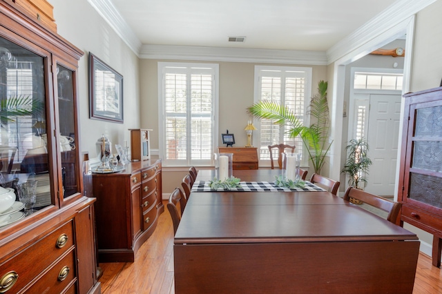 interior space featuring crown molding, a wealth of natural light, and light wood-type flooring