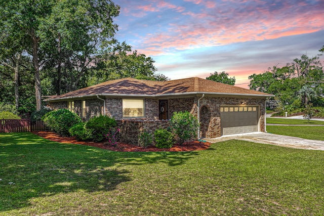 ranch-style house with a yard and a garage