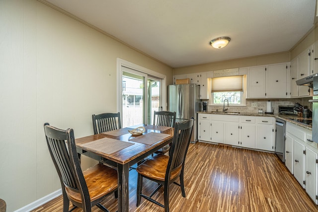 dining area featuring ornamental molding, dark hardwood / wood-style floors, and plenty of natural light