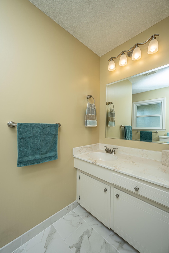 bathroom featuring vanity and a textured ceiling