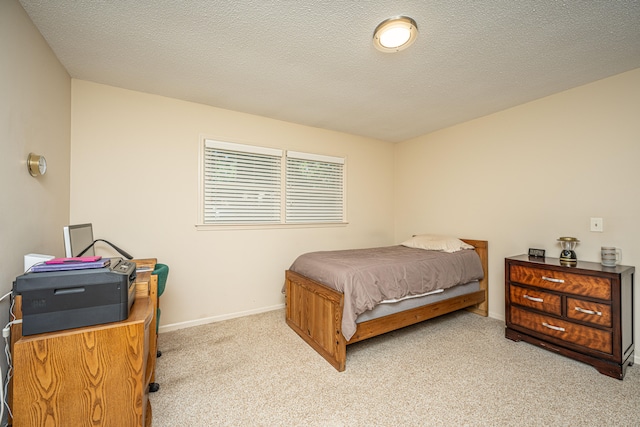 carpeted bedroom featuring a textured ceiling