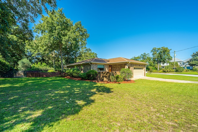 ranch-style home with a front yard and a garage