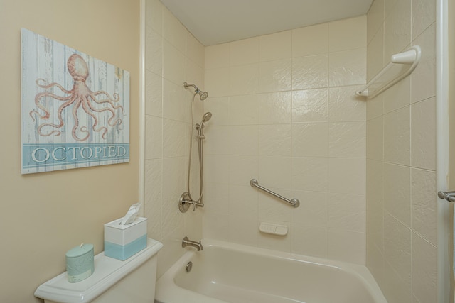 bathroom featuring toilet and tiled shower / bath combo