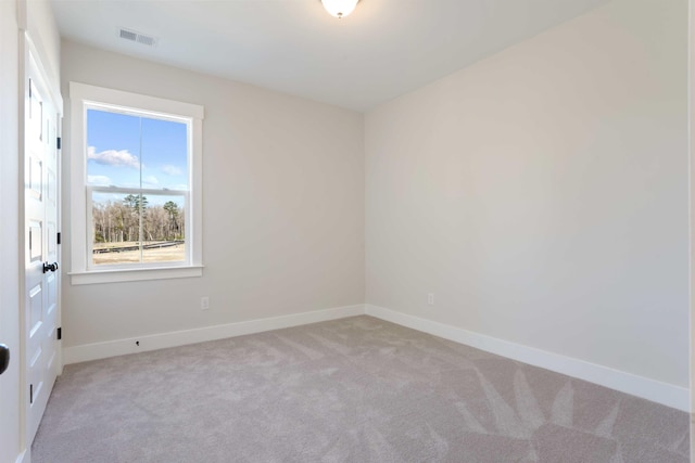 carpeted spare room with visible vents and baseboards