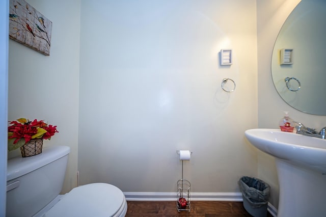 bathroom with sink, toilet, and hardwood / wood-style floors