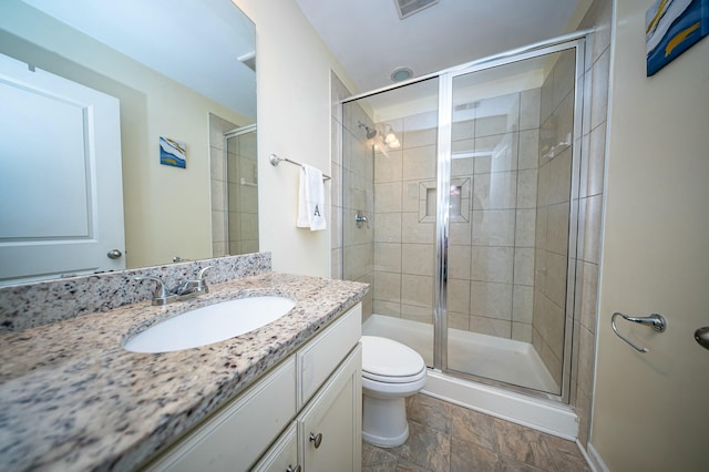 bathroom featuring walk in shower, vanity, and toilet