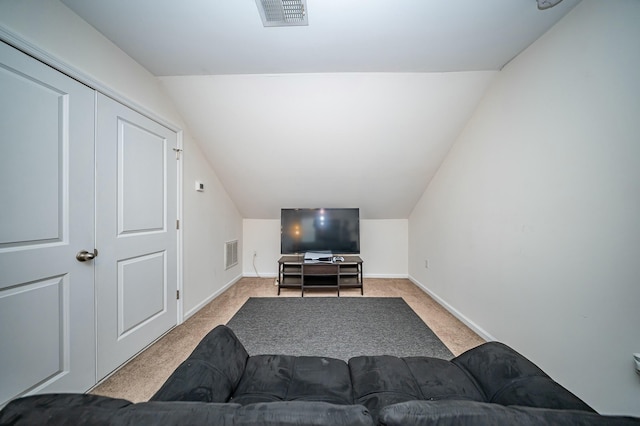 carpeted living room featuring vaulted ceiling