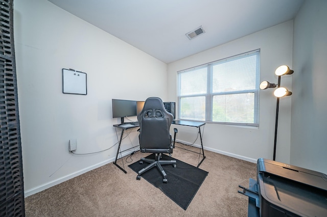 carpeted office with vaulted ceiling