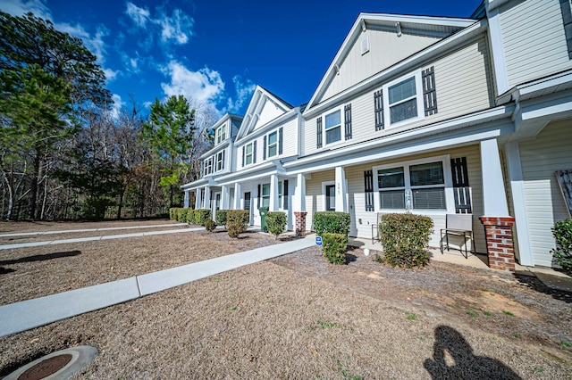 townhome / multi-family property featuring covered porch