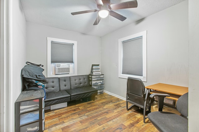 office area with ceiling fan, cooling unit, dark hardwood / wood-style flooring, and a textured ceiling