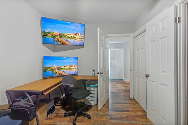 office with dark hardwood / wood-style flooring and a textured ceiling