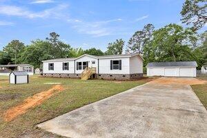 119 Silver King Ave, Cross, SC 29436 - manufactured / mobile home featuring crawl space, a front yard, a storage shed, an outbuilding, and a detached garage
