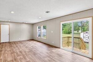 119 Silver King Ave, Cross, SC 29436 - unfurnished living room featuring plenty of natural light, recessed lighting, wood finished floors, and visible vents