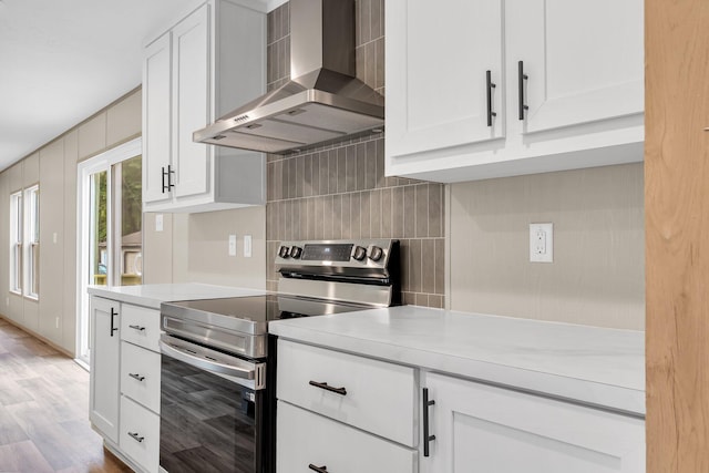 119 Silver King Ave, Cross, SC 29436 - kitchen featuring wall chimney range hood, decorative backsplash, electric range, light countertops, and white cabinetry