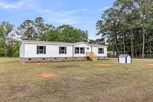 119 Silver King Ave, Cross, SC 29436 - view of front of home featuring a storage shed, an outdoor structure, a front lawn, and crawl space