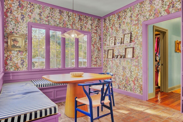 dining room with breakfast area and crown molding