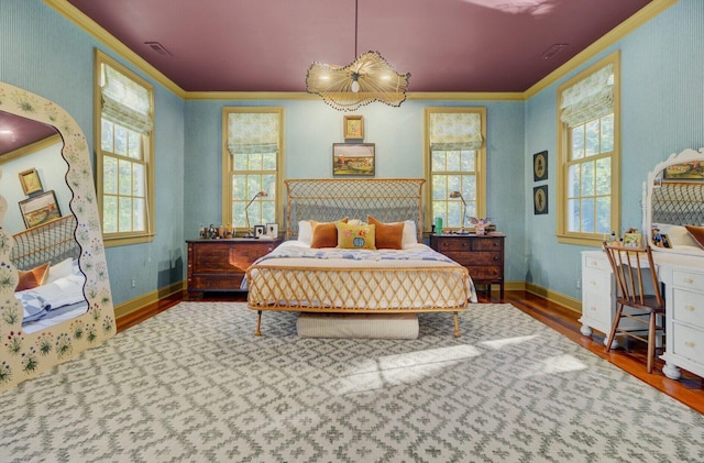 bedroom with wood-type flooring and ornamental molding