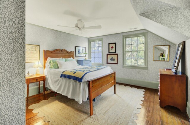 bedroom with hardwood / wood-style floors, ceiling fan, and lofted ceiling