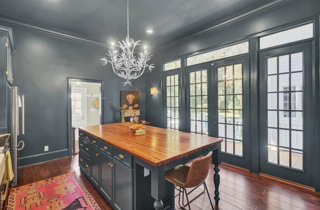 dining area featuring plenty of natural light, dark wood-type flooring, a chandelier, and french doors