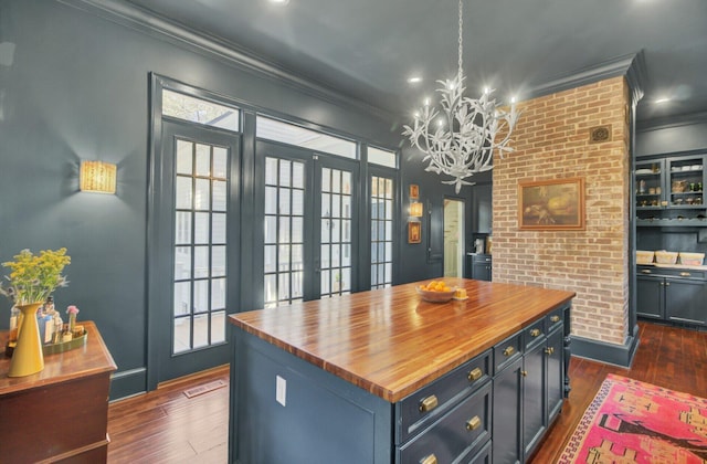 kitchen with french doors, a center island, dark hardwood / wood-style floors, butcher block countertops, and a chandelier