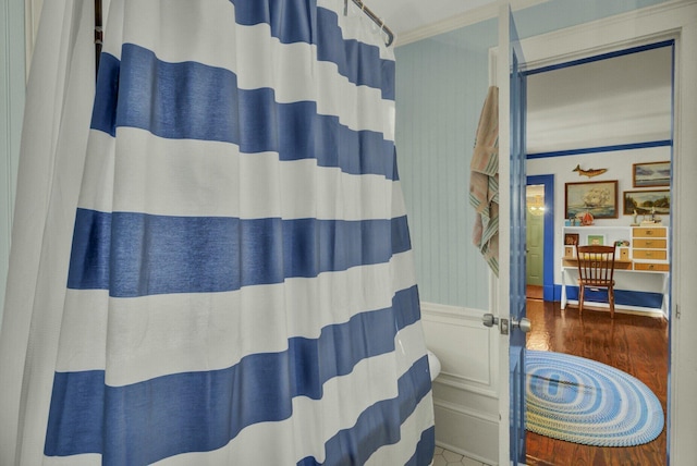 bathroom featuring crown molding and hardwood / wood-style flooring