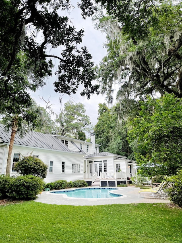 rear view of property with a yard