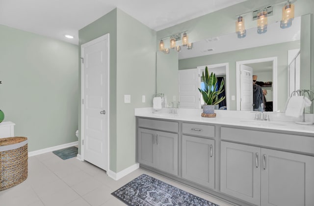 bathroom with vanity, toilet, and tile patterned floors