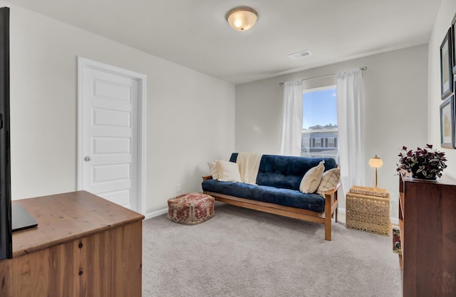 sitting room featuring light carpet