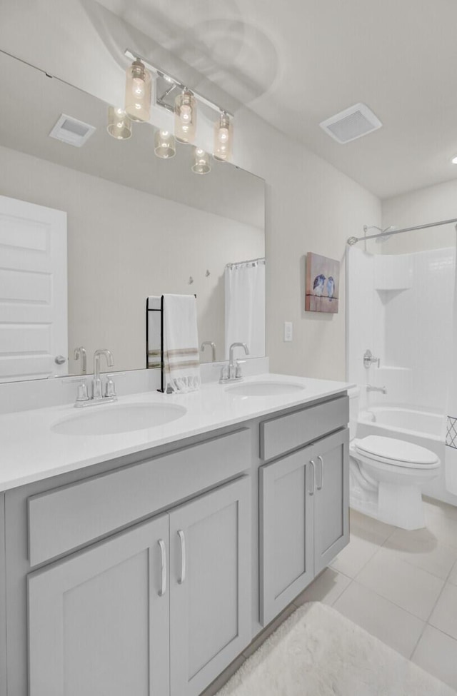 full bathroom featuring shower / bath combination with curtain, vanity, tile patterned flooring, and toilet