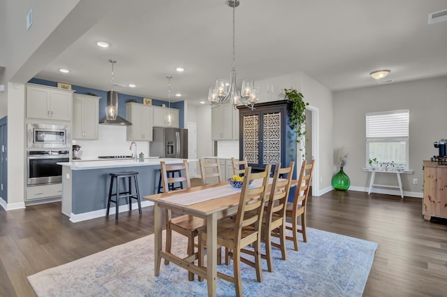 dining area with dark wood-type flooring and sink