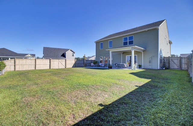 rear view of house with a lawn and a patio area