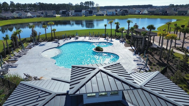 view of swimming pool featuring a patio area and a water view