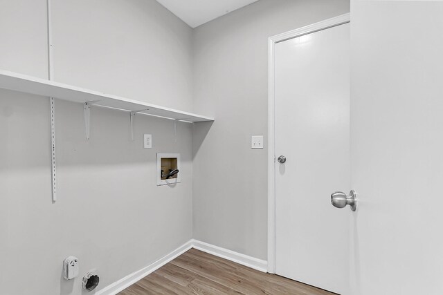 laundry area with baseboards, wood finished floors, laundry area, and washer hookup