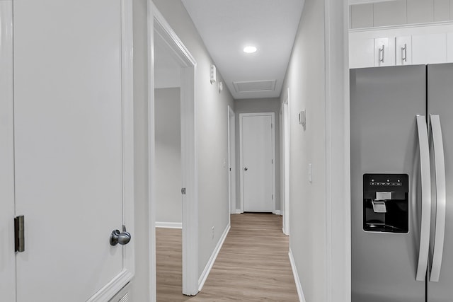 hallway with attic access, baseboards, light wood-style floors, and recessed lighting