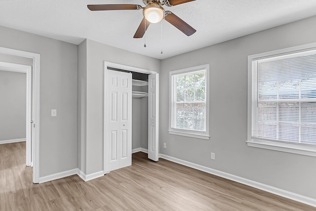 unfurnished bedroom with light wood finished floors, baseboards, a closet, and ceiling fan