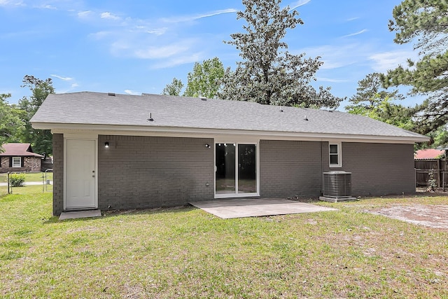 rear view of house with a lawn, central AC, a patio, and fence