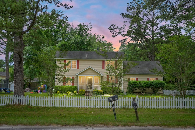 colonial house featuring a yard