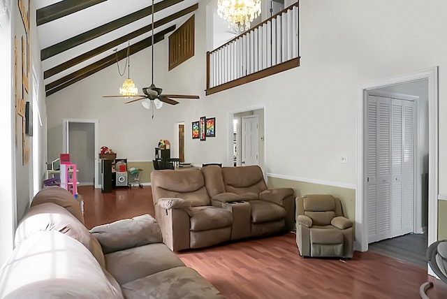 living room with wood-type flooring, high vaulted ceiling, ceiling fan with notable chandelier, and beamed ceiling