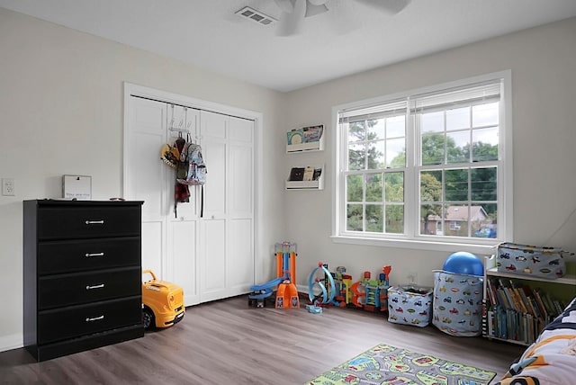 game room with ceiling fan and dark hardwood / wood-style flooring